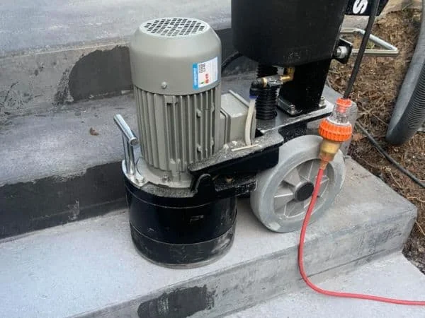 Specialist honing machine mechanically refining concrete steps