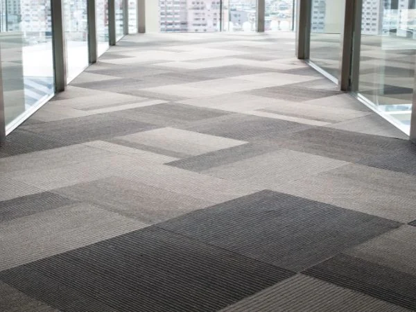 Completed commercial office corridor with patterned modular carpet tiles