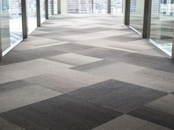 Commercial corridor finished in patterned carpet tiles